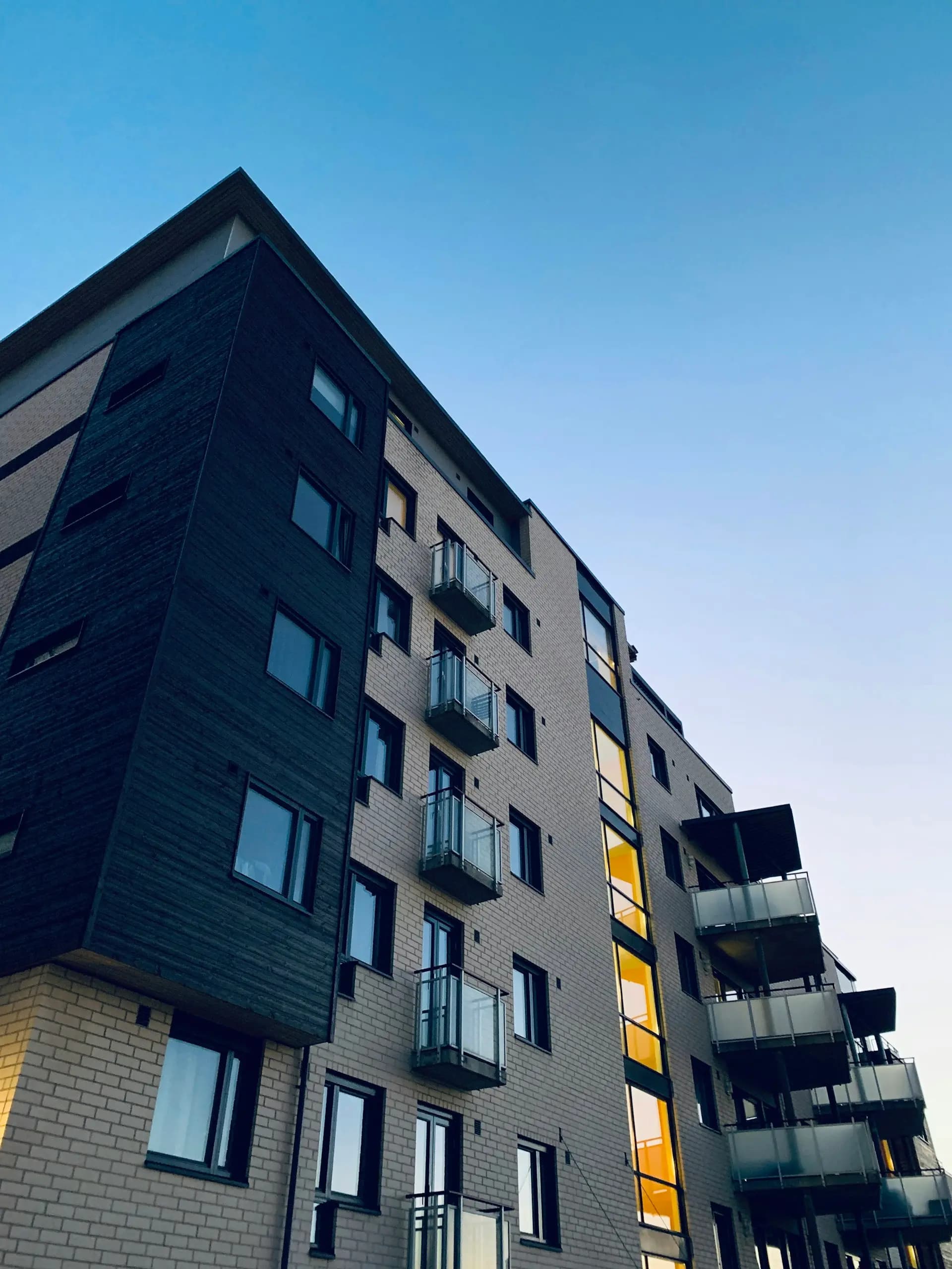 Apartment building facade against a clear evening sky