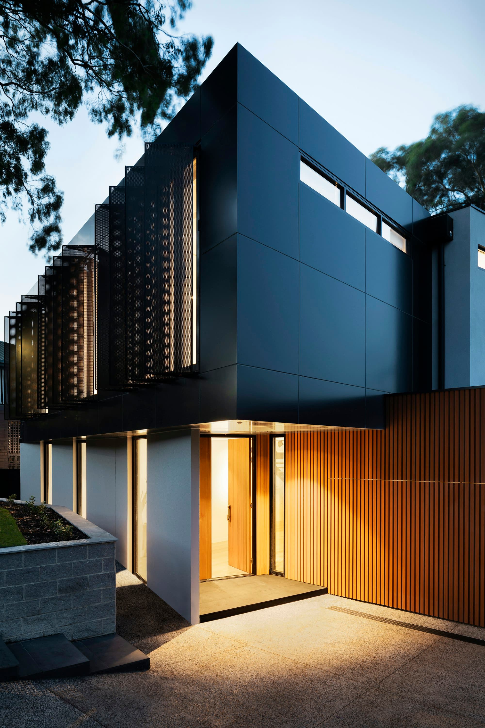 Modern residence entrance detail lit at dusk
